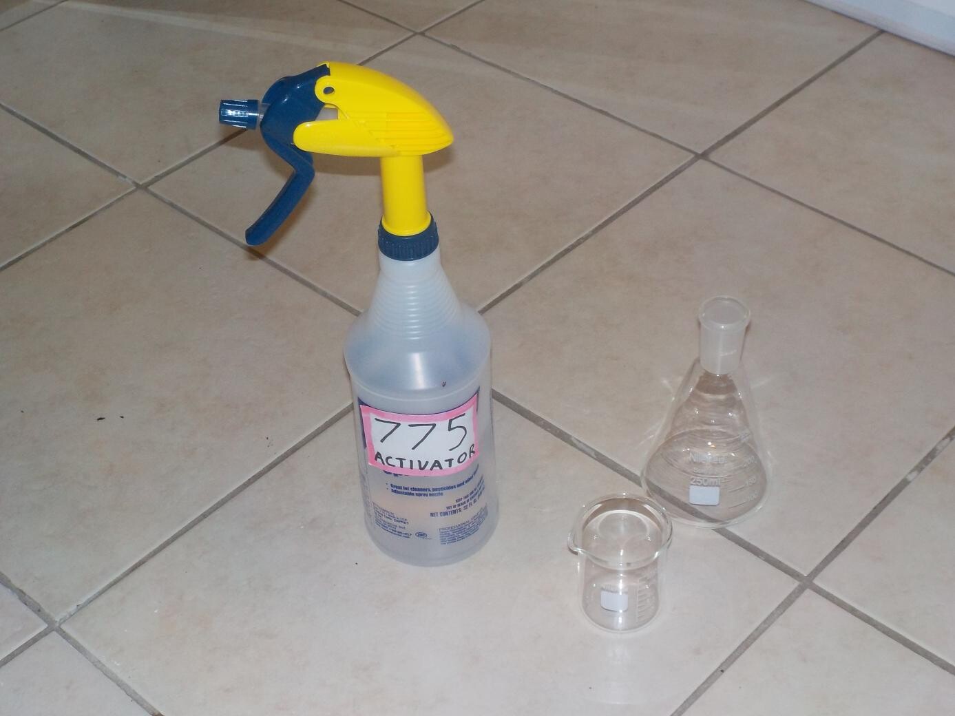 sprayer of 775 Activator with a beaker and flask