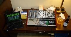 Small Eurorack synthesizer on a hotel desk